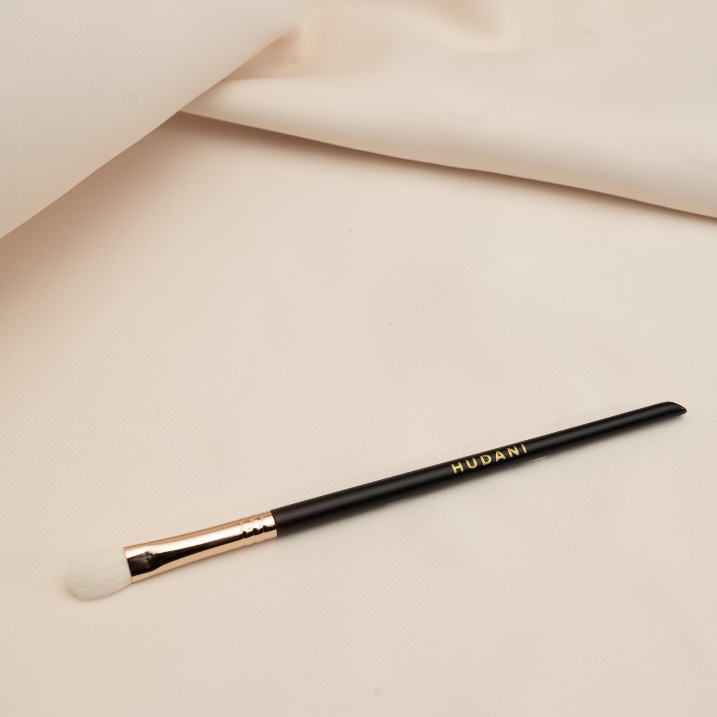 This is a white haired blending brush and it has a wooden handle.