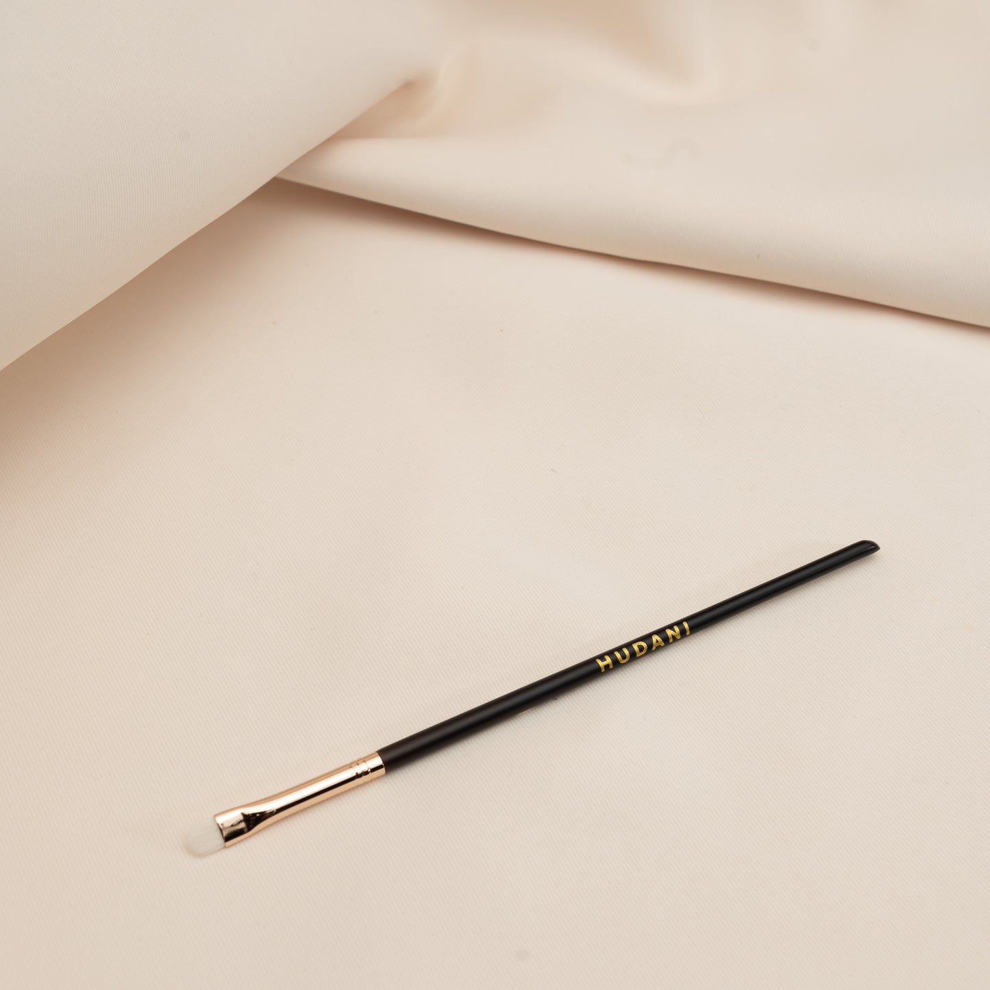This is a very small detailed eyeshadow brush and it has a wooden handle.