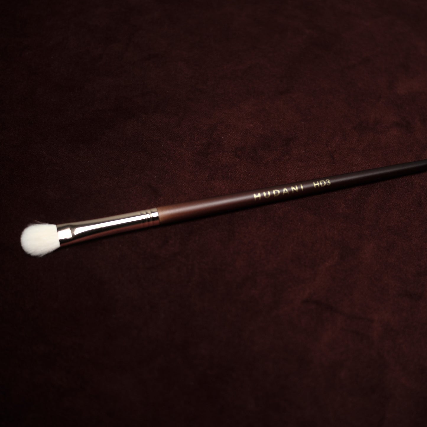 This is a detailed natural haired eyeshadow blending brush with a wooden handle.