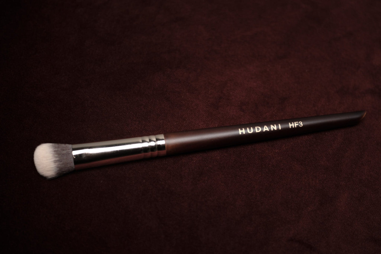 This is a duo fiber angled concealer brush and it has a wooden handle.