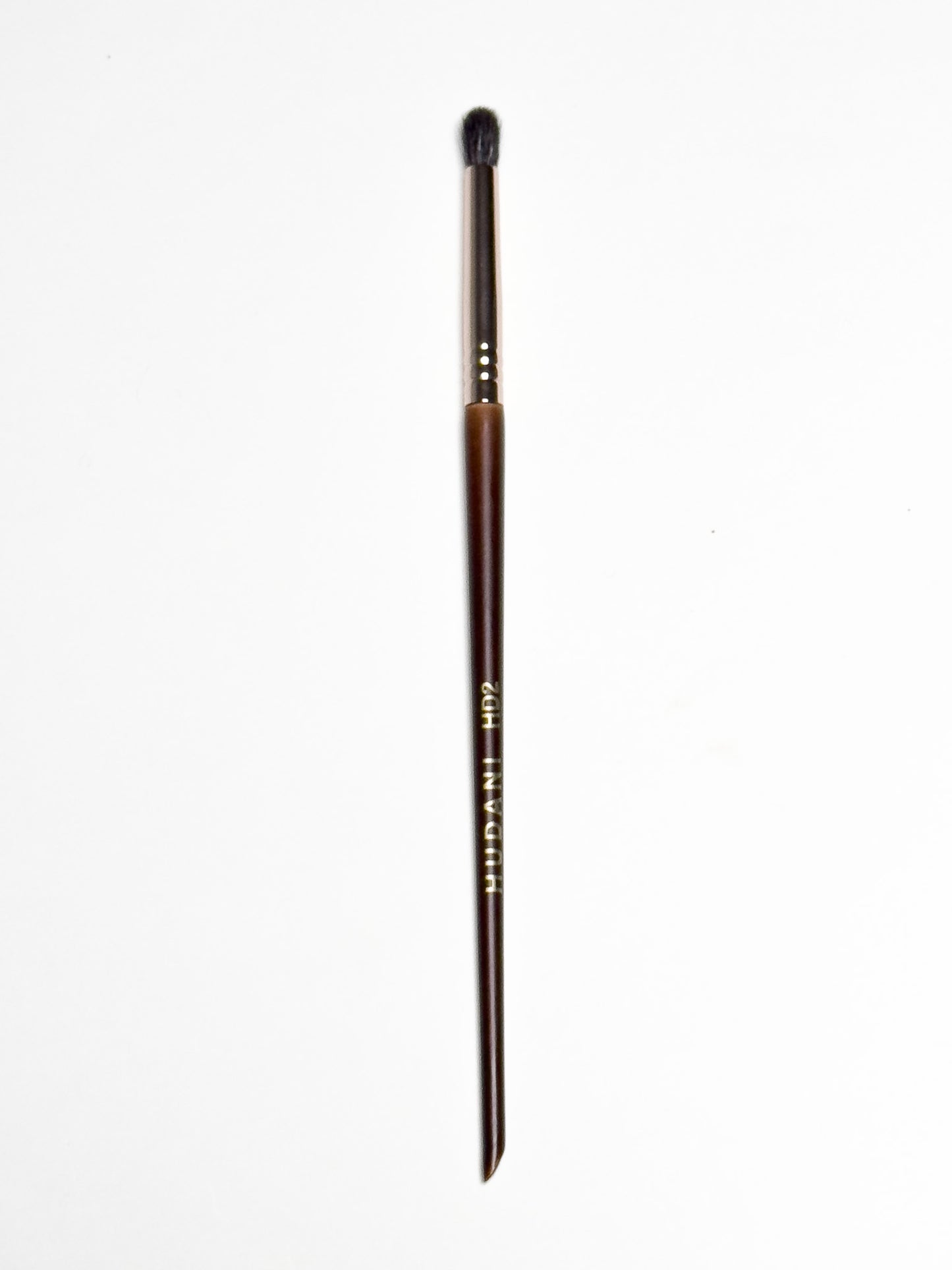This is a fluffy rounded synthetic brush for your eyes and it has a wooden handle.