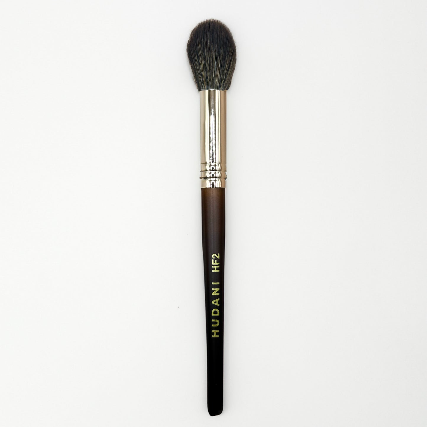 This is a tapered powder brush and it has a wooden handle.