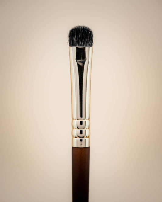 This is a flat synthetic lid brush and it has a wooden handle.